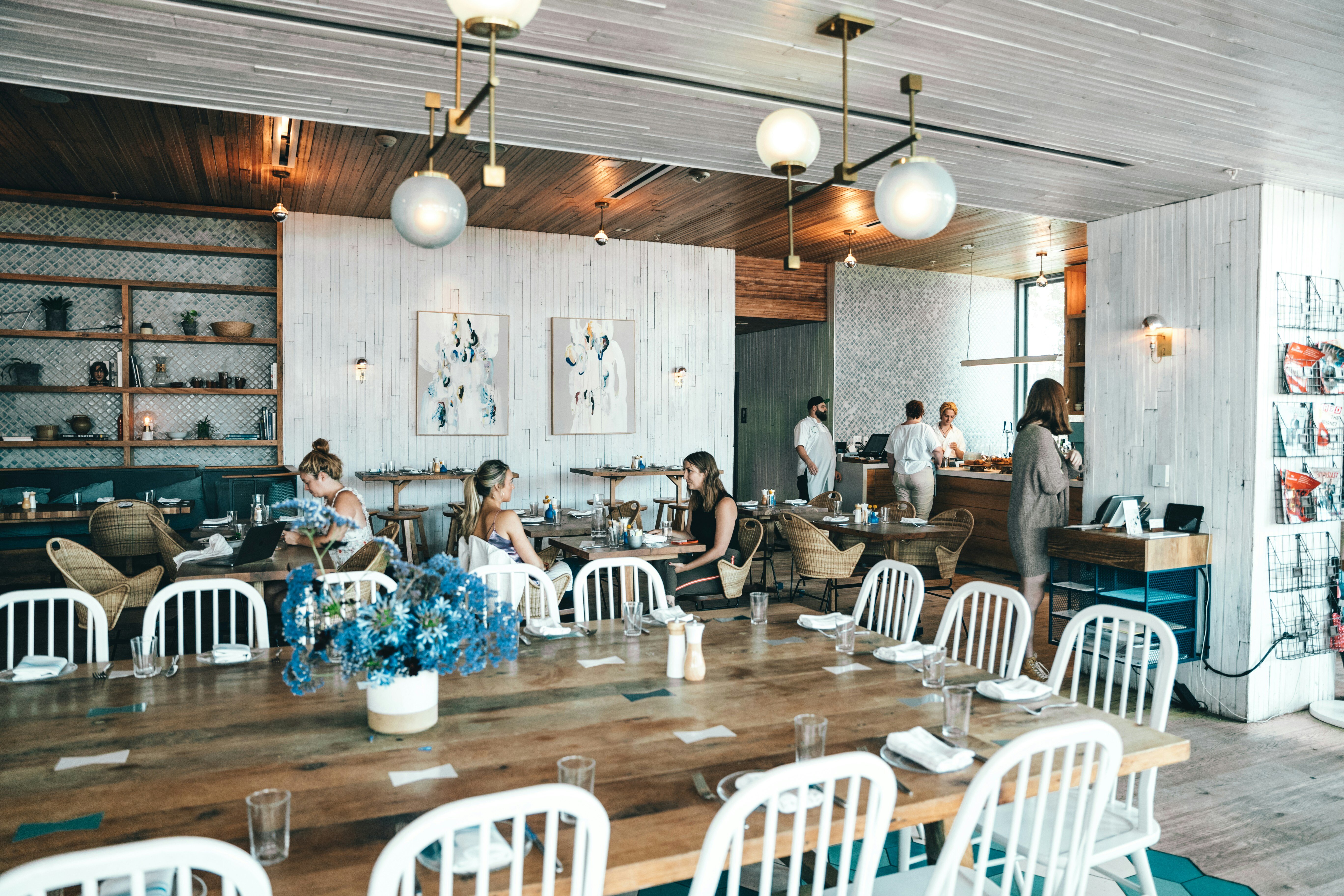 A few guests in a bright and comfortable café