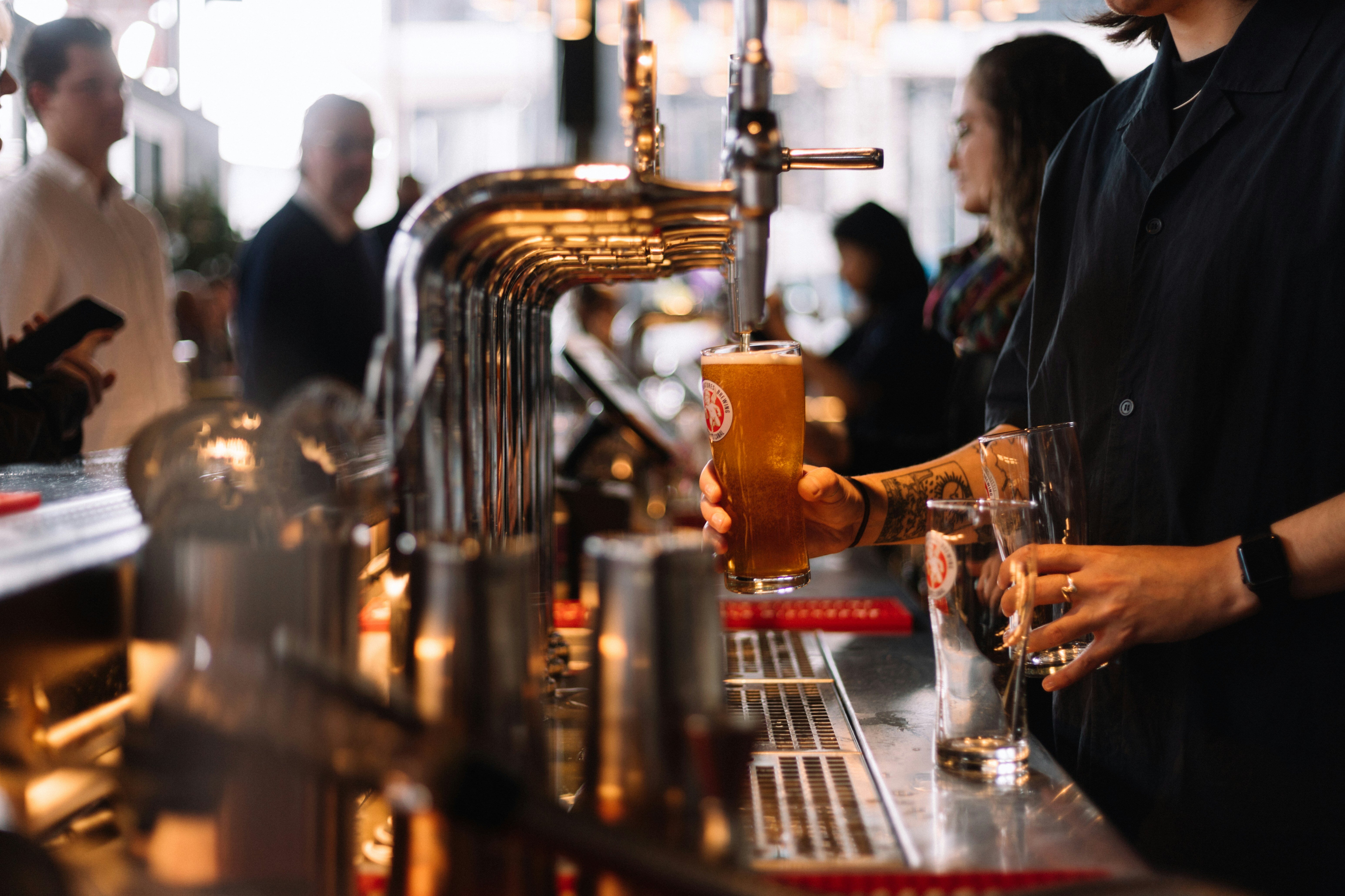 Employee taps beer in a restaurant