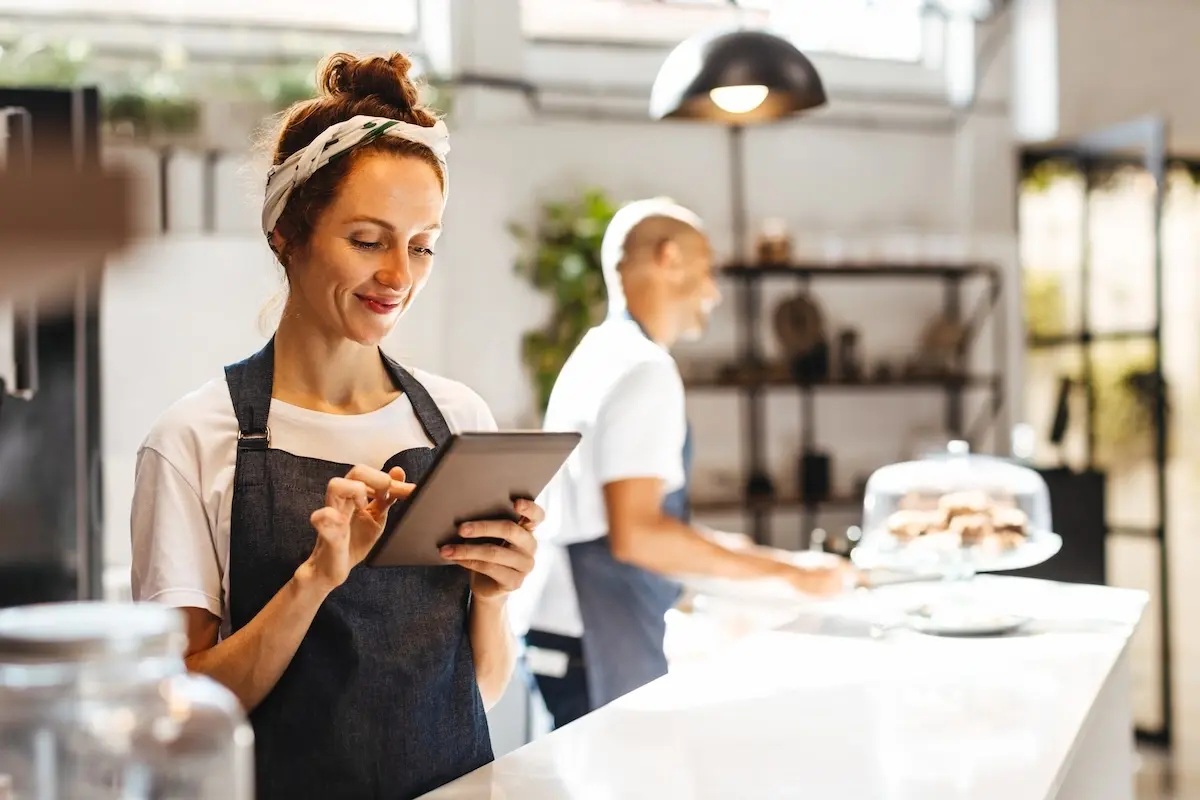 Restaurant manager working on tablet